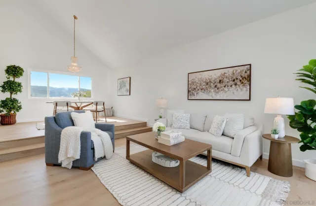a living room with furniture a rug and a chandelier