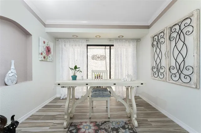 a dining room with furniture and potted plants