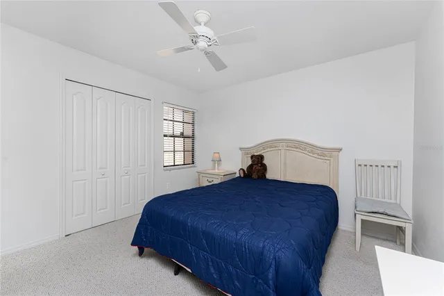 a bedroom with bed and window