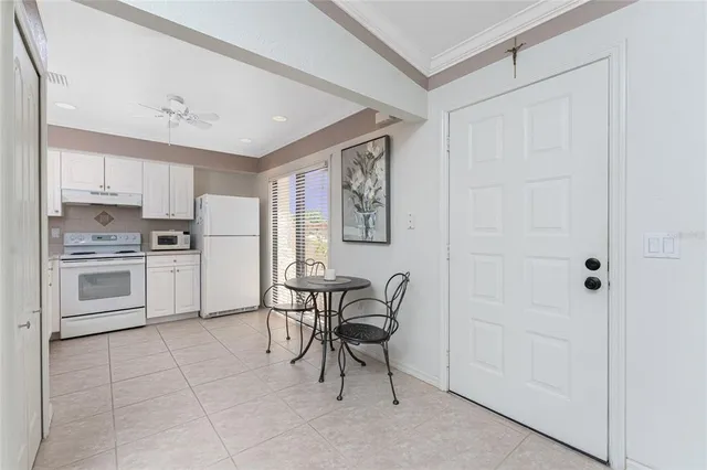 a kitchen with white cabinets and stainless steel appliances