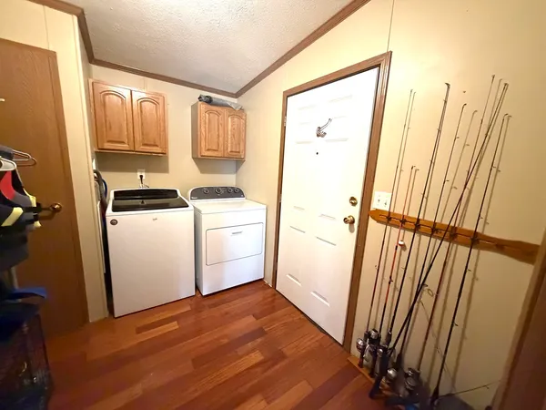 a view of a kitchen with wooden floor and electronic appliances