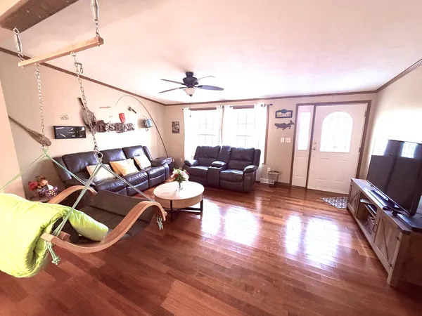 a living room with furniture window and wooden floor