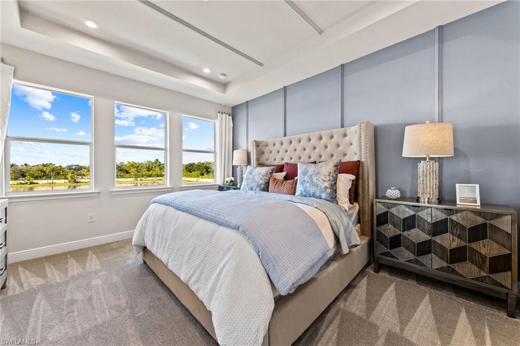 4551 Arboretum Circle, Unit 203 Naples, FL 34112 - Photo 12 of 22 a bed room with a bed and a lamp