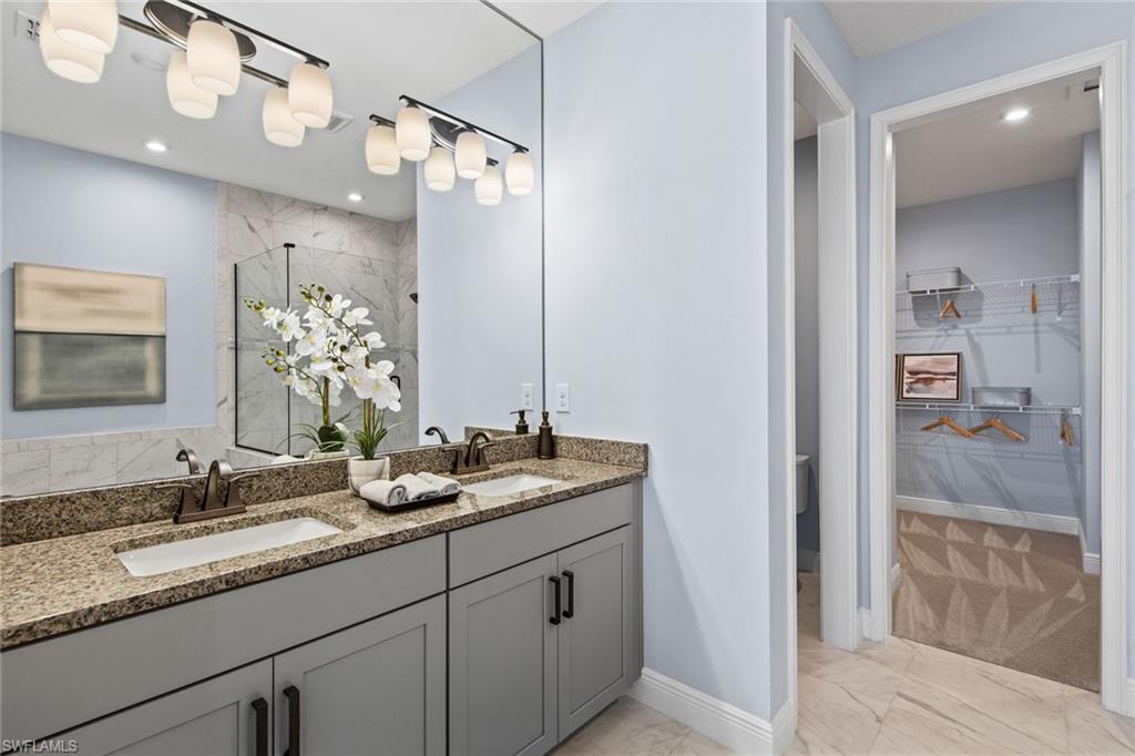 4551 Arboretum Circle, Unit 203 Naples, FL 34112 - Photo 13 of 22 a bathroom with a sink and a mirror