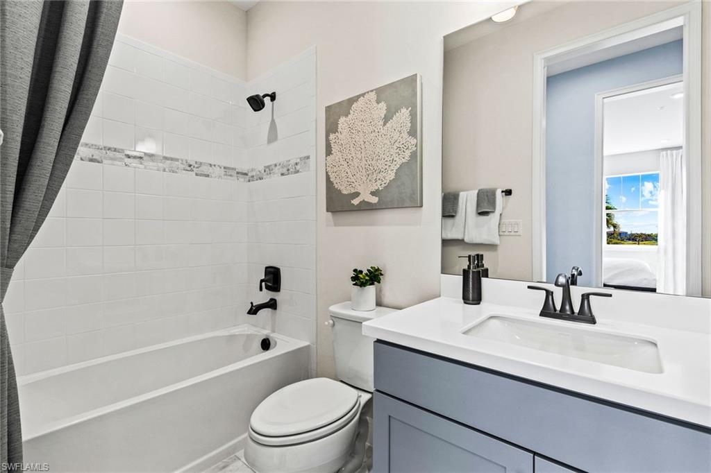 4551 Arboretum Circle, Unit 203 Naples, FL 34112 - Photo 16 of 22 a bathroom with a granite countertop sink a toilet and shower