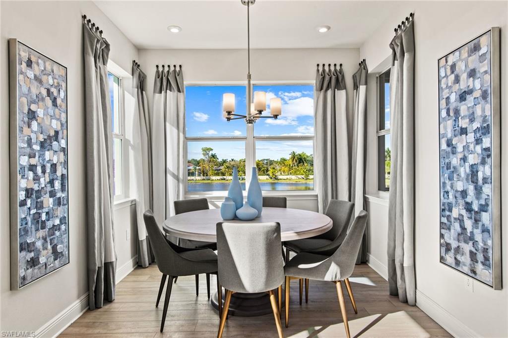 4551 Arboretum Circle, Unit 203 Naples, FL 34112 - Photo 7 of 22 a dining room with furniture window wooden floor