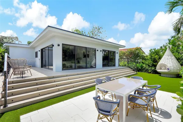 a view of a patio with table and chairs and potted plants