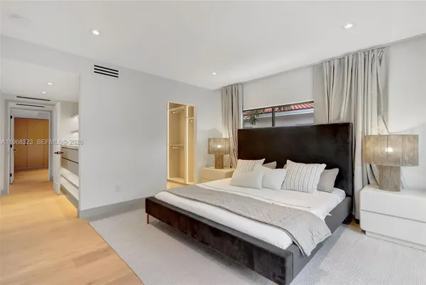 a bedroom with a bed and a lamp