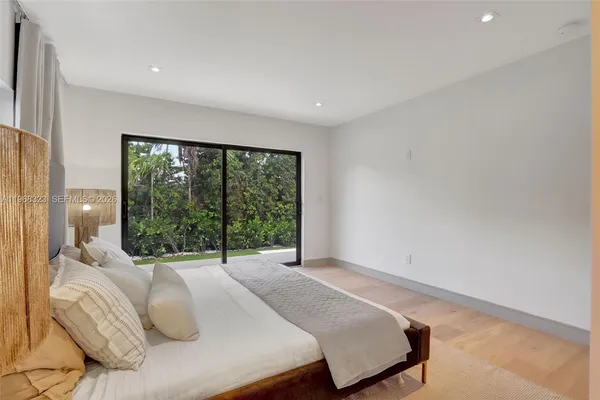 a bedroom with a large bed and a large window