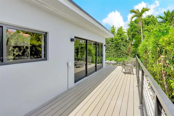 a view of balcony with wooden floor and fence