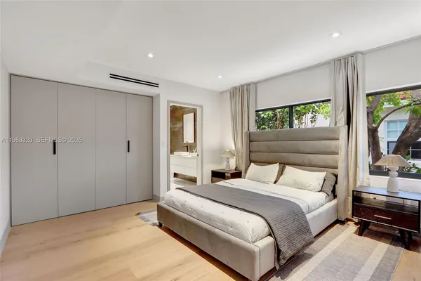 a bedroom with a bed and a large window