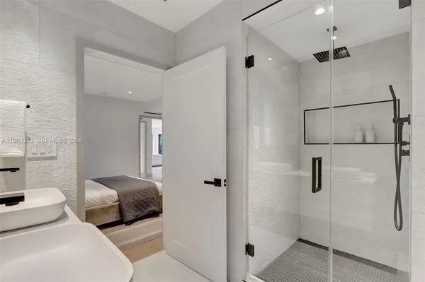 a bedroom with a bed and a shower