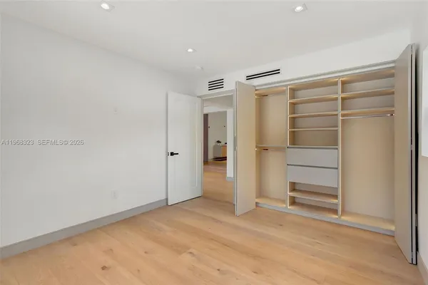 a view of an empty room with a closet