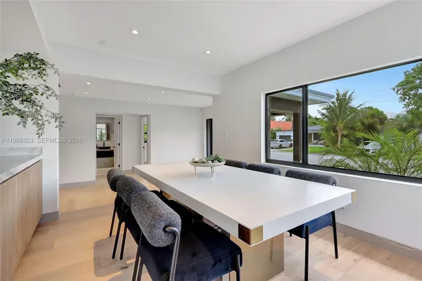 a view of a dining room with furniture and window