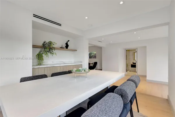 a bedroom with a bed and a potted plant on table
