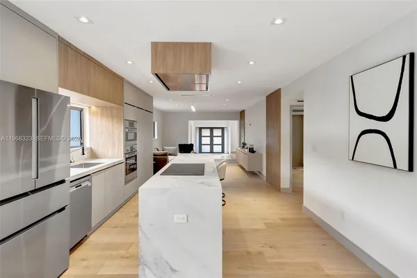 a kitchen with stainless steel appliances granite countertop a refrigerator and a sink