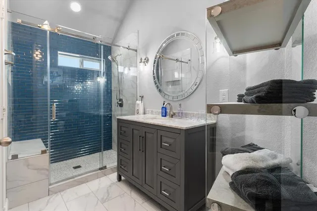 a bathroom with a double vanity sink a toilet a mirror and shower