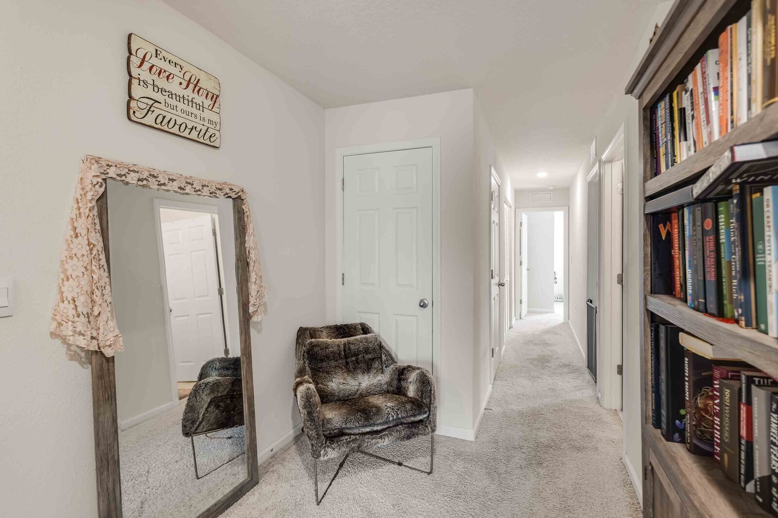 86784 Mainline Road Yulee, FL 32097 - Photo 12 of 25 a hallway with furniture and a book shelf