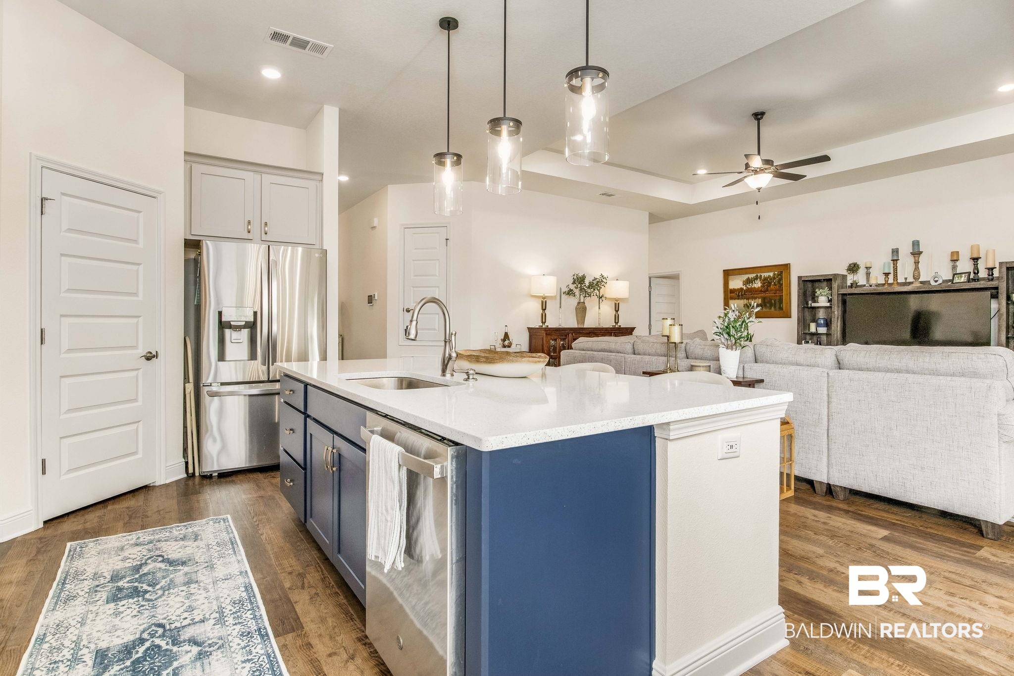 2222 Club House Drive Lillian, AL 36549 - Photo 6 of 49 Kitchen featuring decorative light fixtures, appliances with stainless steel finishes, blue cabinets, light stone counters, and dark wood-style floors