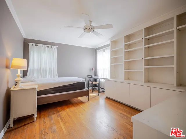 a spacious bedroom with a bed and a window