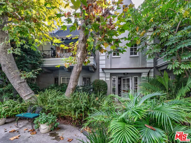 front view of a house with a tree