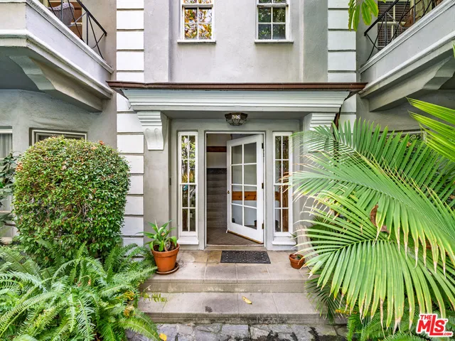 a view of a building with potted plants