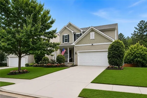a view of a house with a yard and deck