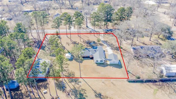 a view of a yard in front of the house with a potted plant