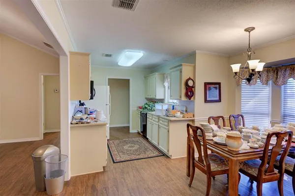 a view of a dining room that has a table and chairs in it