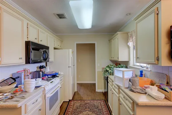 a kitchen that has a sink and a stove in it