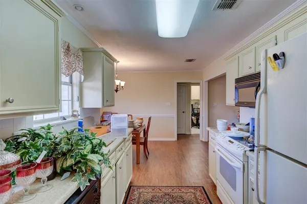 a kitchen with furniture and a potted plant