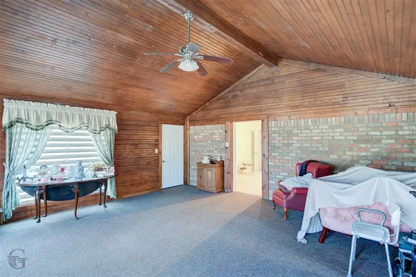 a bedroom with furniture and a window