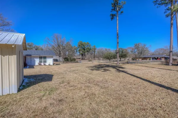 a view of road with house and car parked