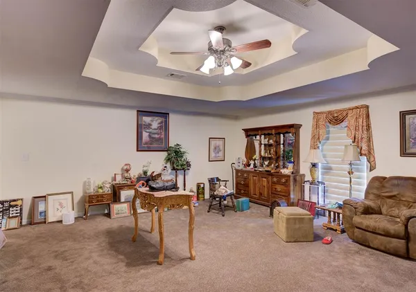 a living room with furniture and a chandelier