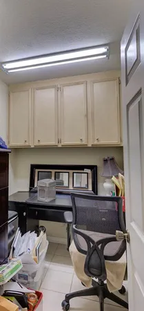 a kitchen with a table chairs stove and cabinets