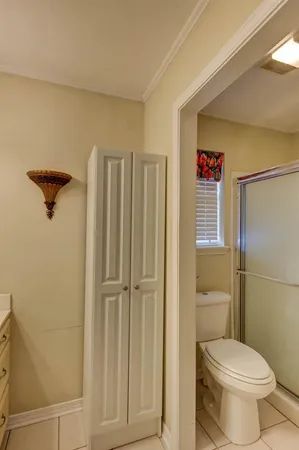 a bathroom with a toilet and a shower