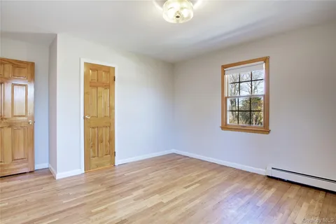 a spacious bedroom with a bed and window