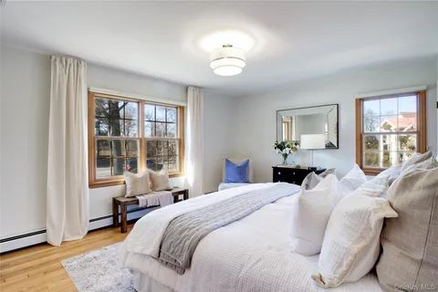 a bedroom with a bed and a large window