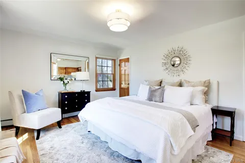 a bathroom with a toilet a sink and a mirror