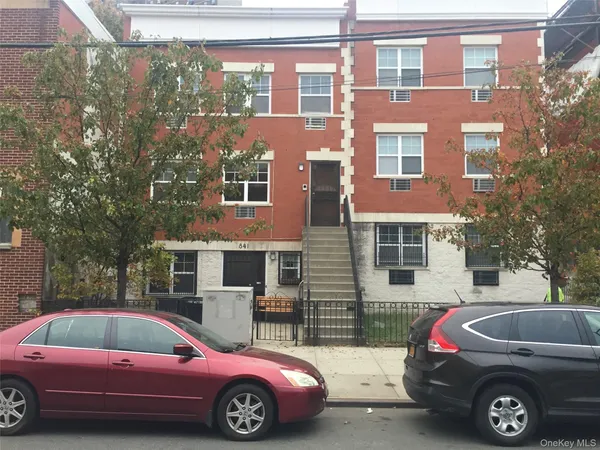 a front view of a house with parking space