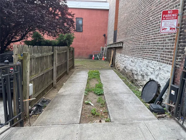 a view of a pathway with a backyard