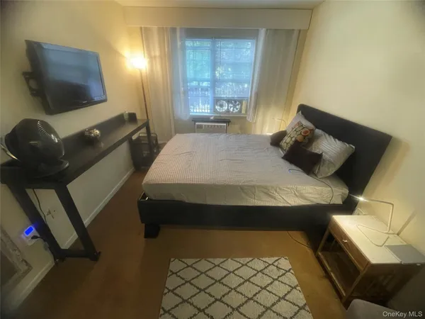 a bedroom with a bed and flat screen tv