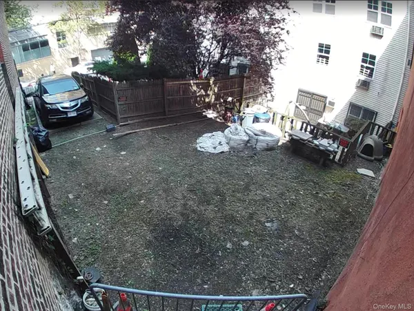 a view of yard with car parked