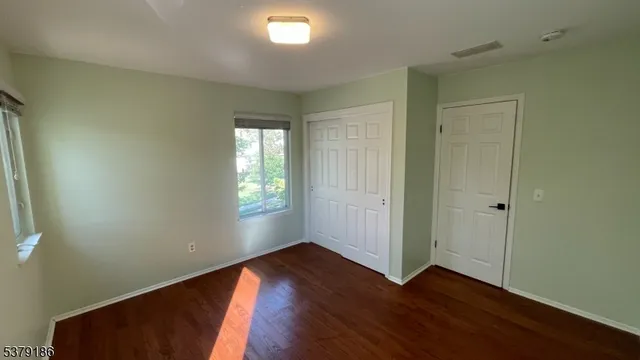 a bathroom with a granite countertop toilet a sink and a large mirror