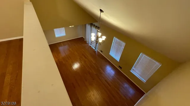 a view of a room with wooden floor