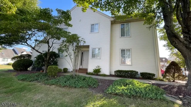 a view of a house with a yard and a garden