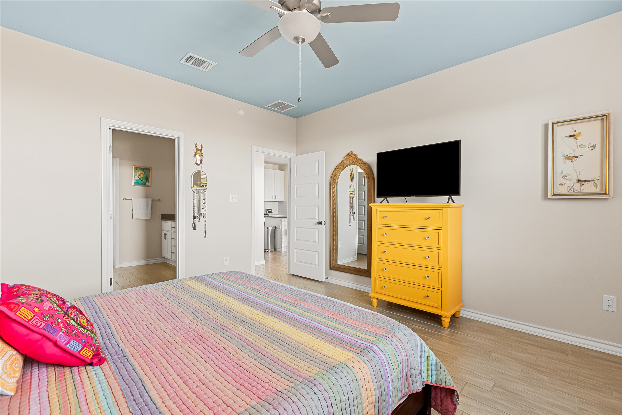 862 Pepperbark Loop Buda, TX 78610 - Photo 17 of 40 a bedroom with a bed and a flat tv screen on dresser