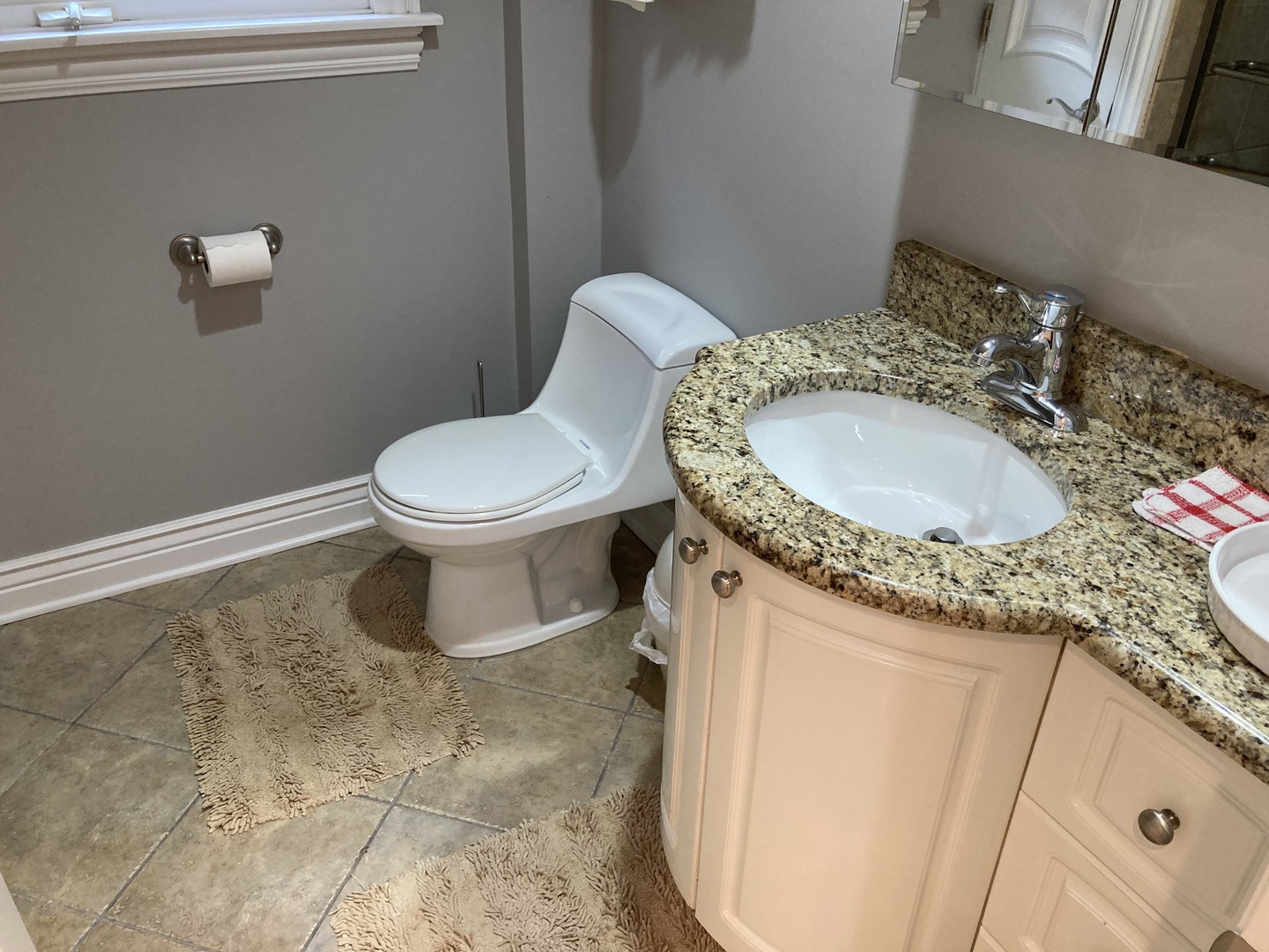8619 West Sunset Road Niles, IL 60714 - Photo 25 of 37 a bathroom with a granite countertop sink a toilet mirror and vanity