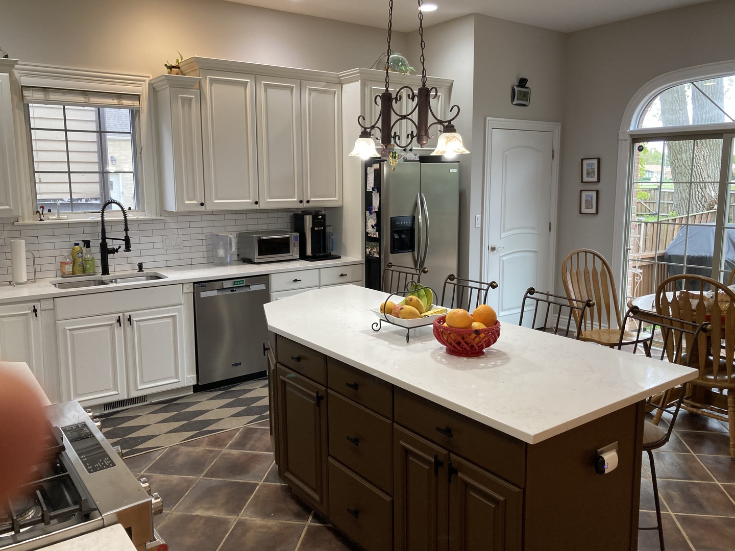 8619 West Sunset Road Niles, IL 60714 - Photo 5 of 37 a kitchen with a sink a stove and chairs