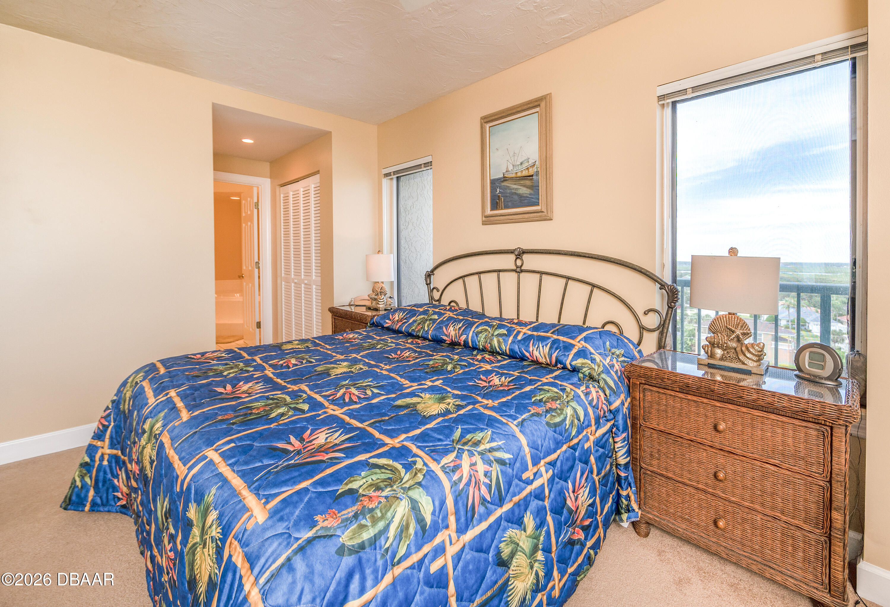 4575 South Atlantic Avenue, Unit 6701 Ponce Inlet, FL 32127 - Photo 18 of 35 a bedroom with a bed a dresser and a window